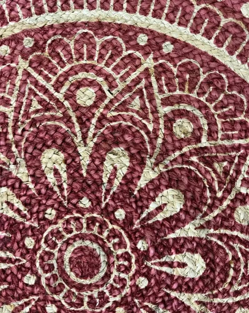 Close-up of a wine red floral print on a jute rug