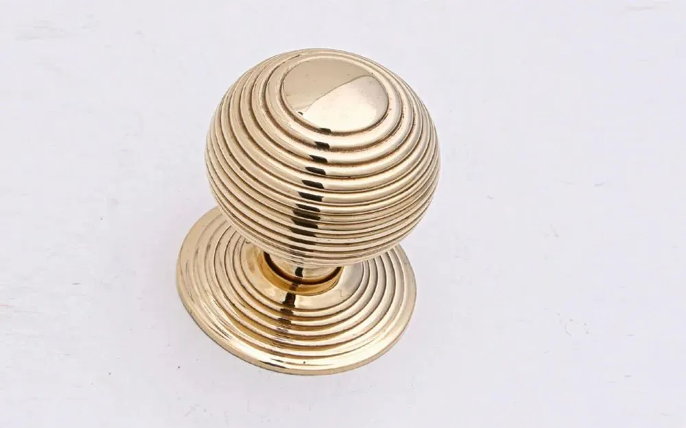 Polished brass beehive cupboard knob, side view