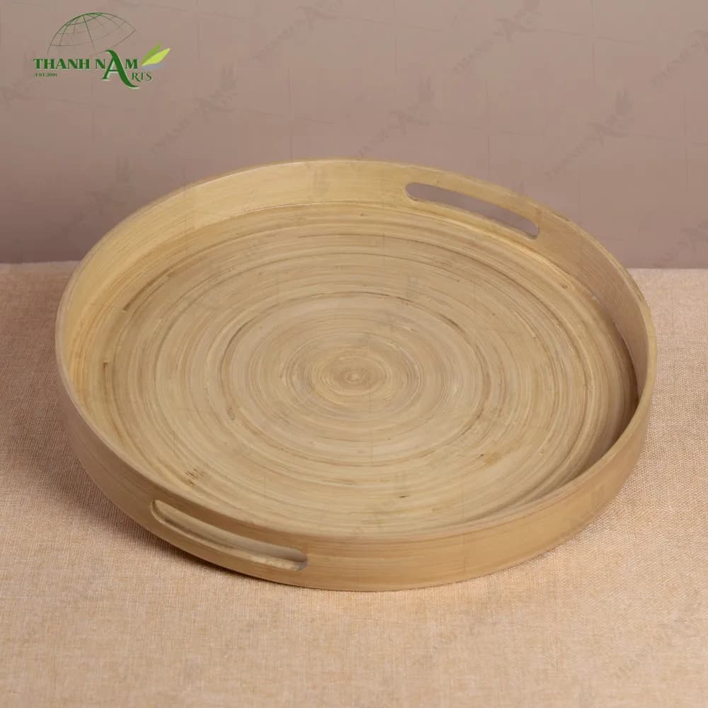 Natural round bamboo serving tray with handle cutouts