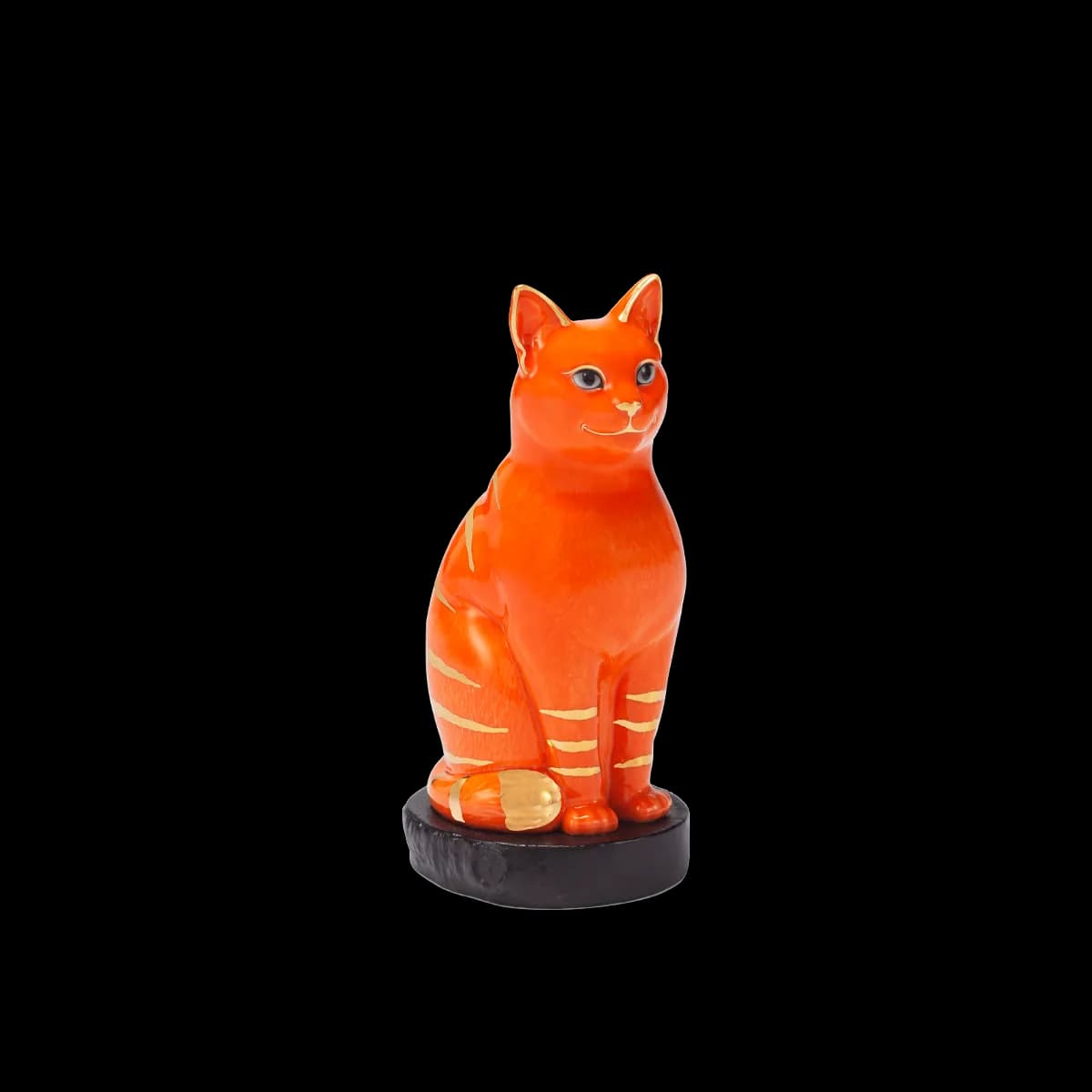 Orange glazed porcelain figurine of a seated cat on a black base