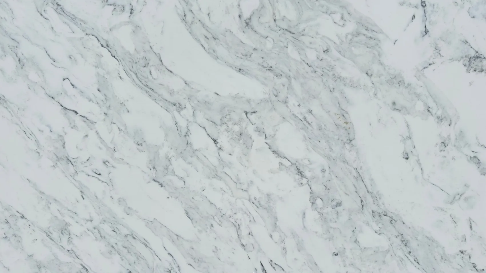 Close view of a white quartz slab surface with soft gray veining