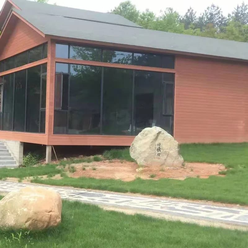Red-brown cladding on a lakeside house