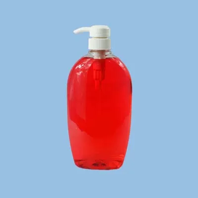 Large oval clear bottle with red liquid and a white pump head