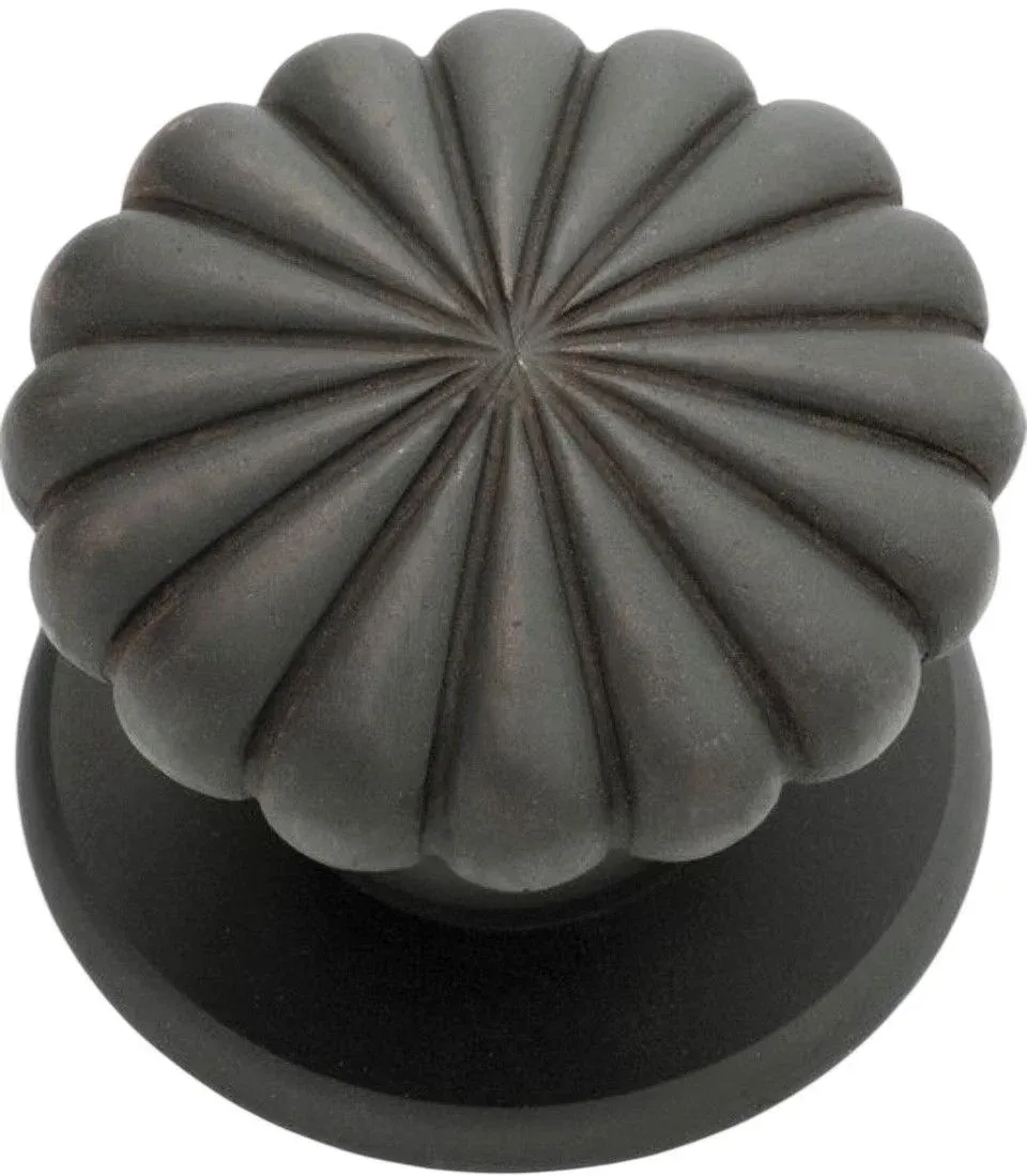 Black cast iron fluted door knob on round rose