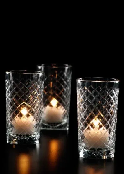 Cut glass tea light votive holders with lit candles