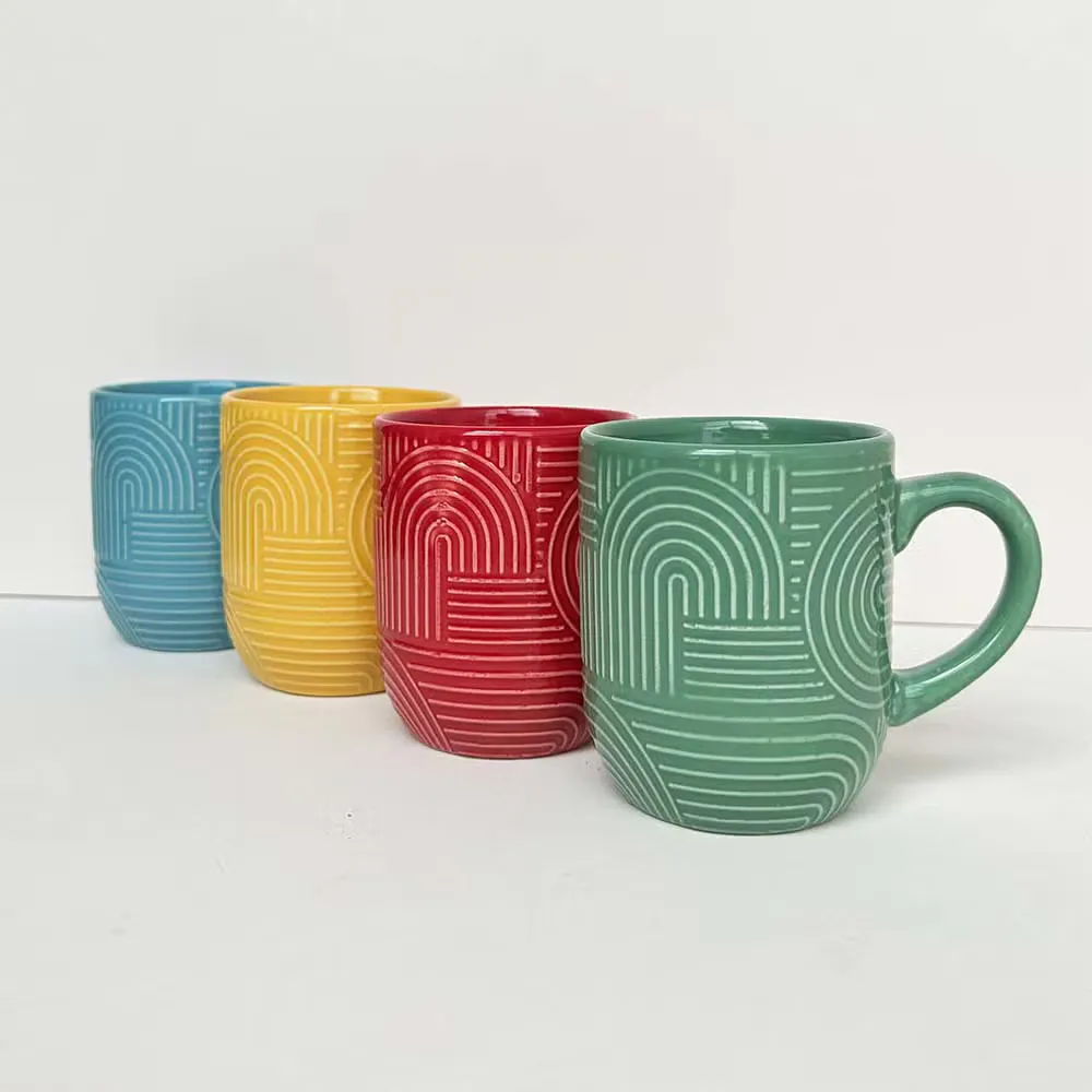 Four embossed pattern stoneware mugs in different colors