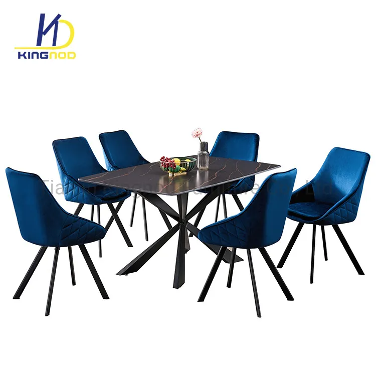 Dining set with blue velvet chairs around a dark table