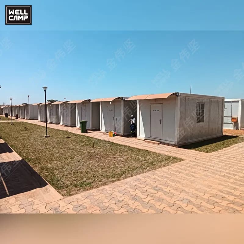 Row of detachable container houses along a paved path