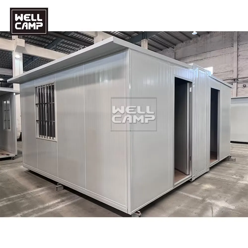Expandable tiny house with barred window in a factory