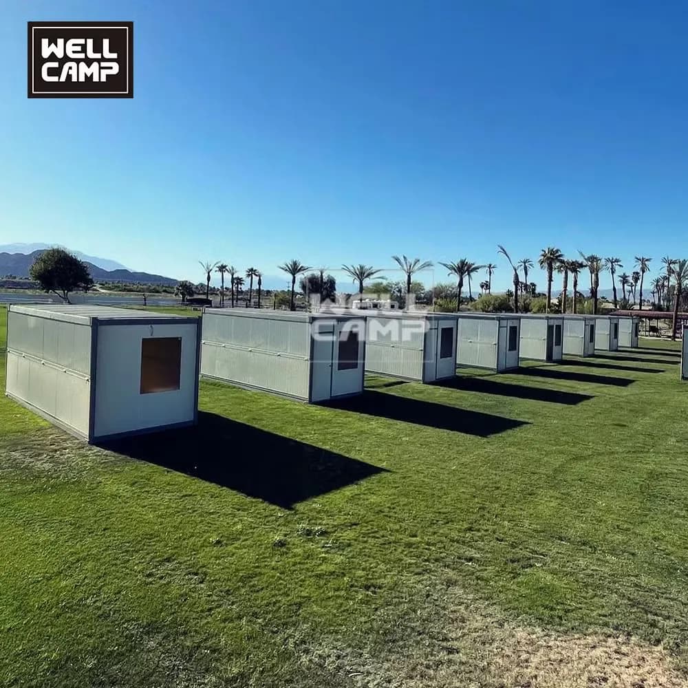 Row of folding container houses on a lawn
