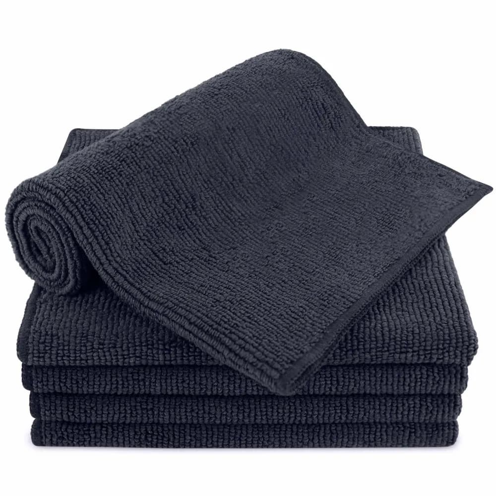 Stack of folded black microfiber towels with one rolled