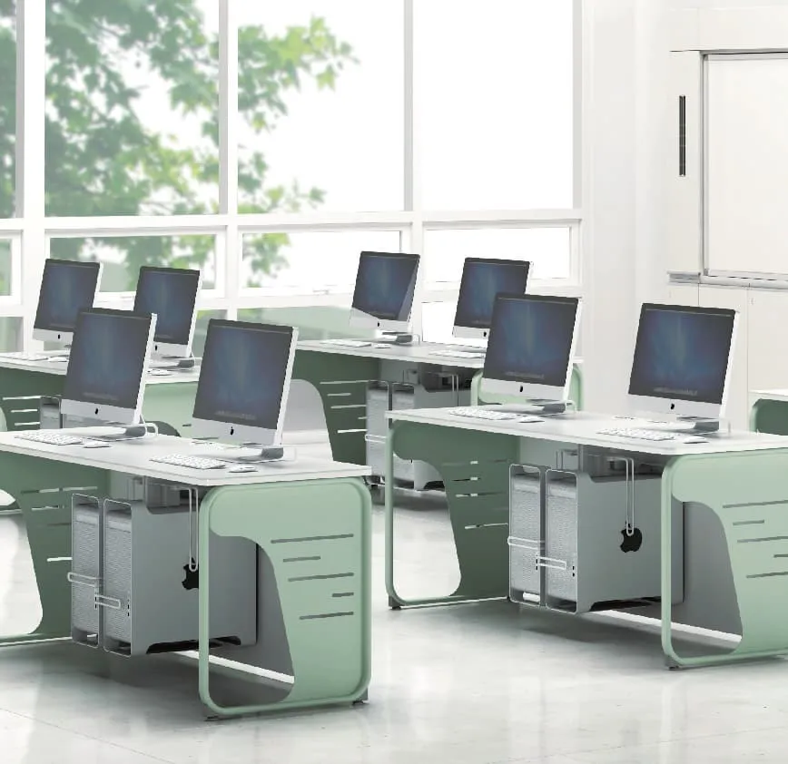 Computer classroom with mint green desks and monitors