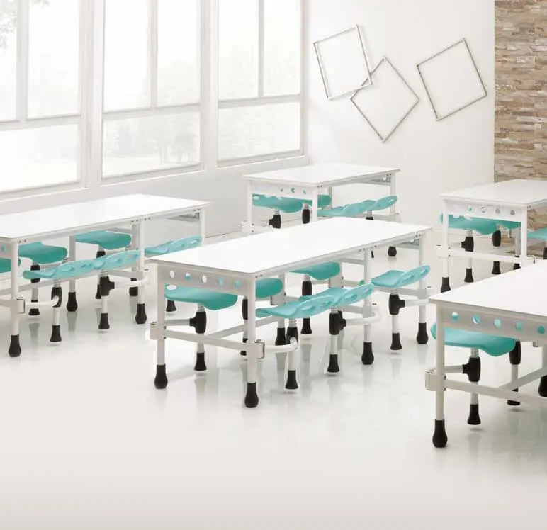 Cafeteria with white tables and teal swing-out stools